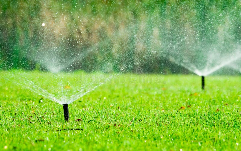 Automatic lawn sprinkler watering green grass. Sprinkler with automatic system. Garden irrigation system watering lawn. Water saving or water conservation from sprinkler system with adjustable head. Automatic lawn sprinkler watering green grass. Sprinkler with automatic system. Garden irrigation system watering lawn. Water saving or water conservation from sprinkler system with adjustable head